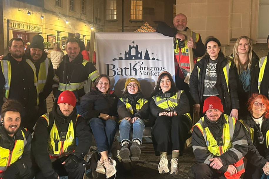 A group photo of Bath Christmas Market crew sat on a branded deckchair