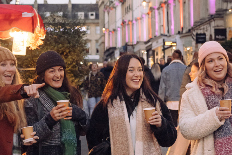 Four women walking through Bath Christmas Market