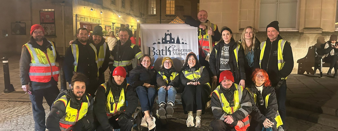 A group photo of Bath Christmas Market crew sat on a branded deckchair