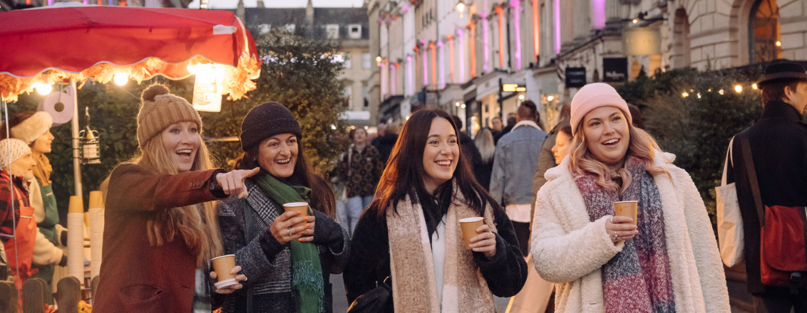 Four women walking through Bath Christmas Market